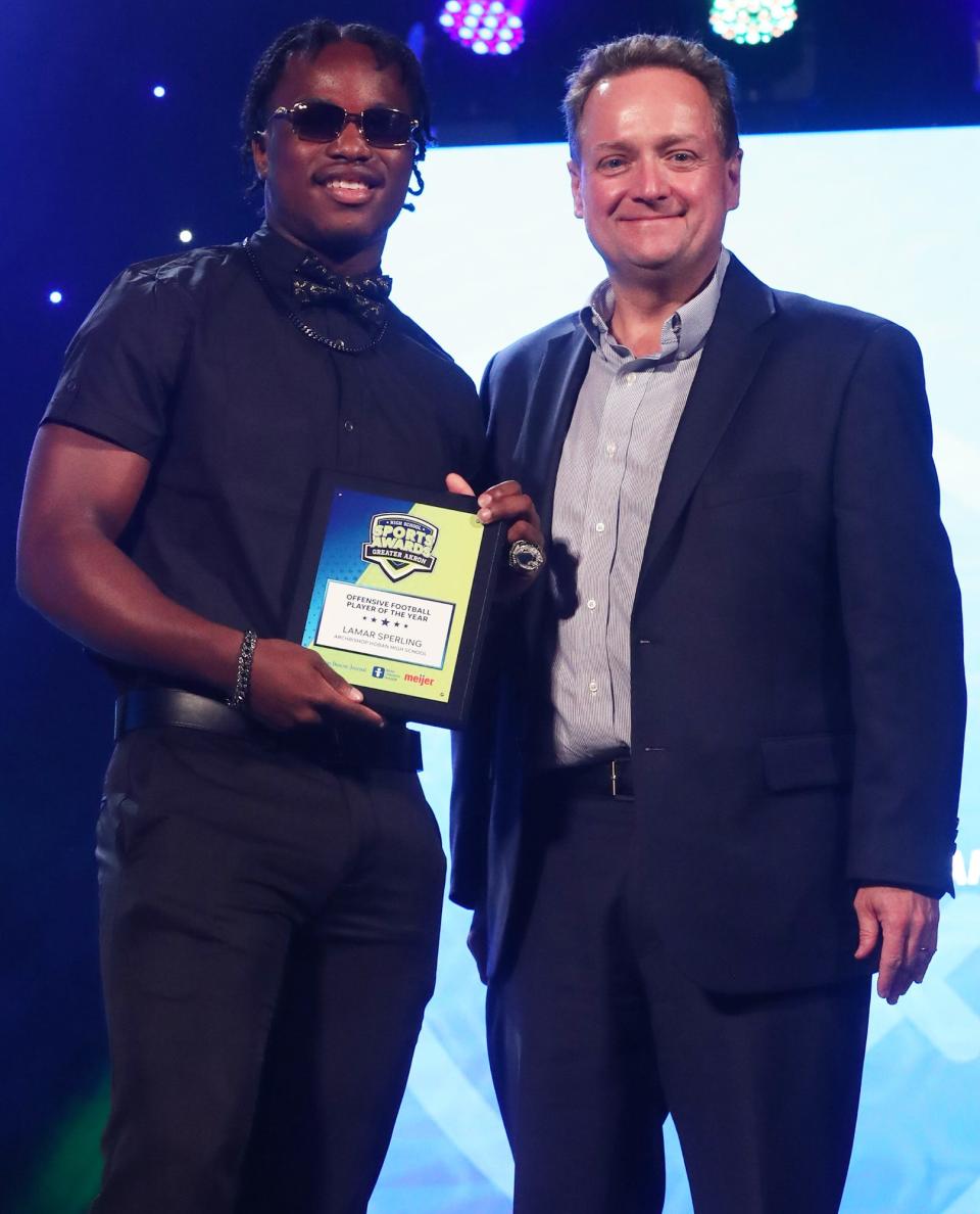 Archbishop Hoban High's Lamar Sperling Greater Akron Football Offensive Player of the Year with Michael Shearer Akron Beacon Journal editor at the High School Sports All-Star Awards at the Civic Theatre in Akron on Friday.