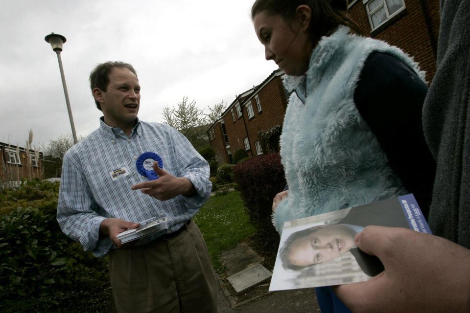 Conservative party candidate Grant Shapps, left, hands out leaflets and talks to residents as he campaigns in Hatfield, north of London, Thursday, April 28, 2005. Hatfield is one of the about 80 districts, known as 