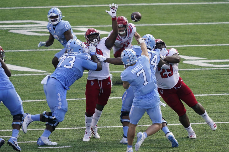 North Carolina State rushes North Carolina quarterback Sam Howell (7) during the first half of an NCAA college football game in Chapel Hill, N.C., Saturday, Oct. 24, 2020. (AP Photo/Gerry Broome)