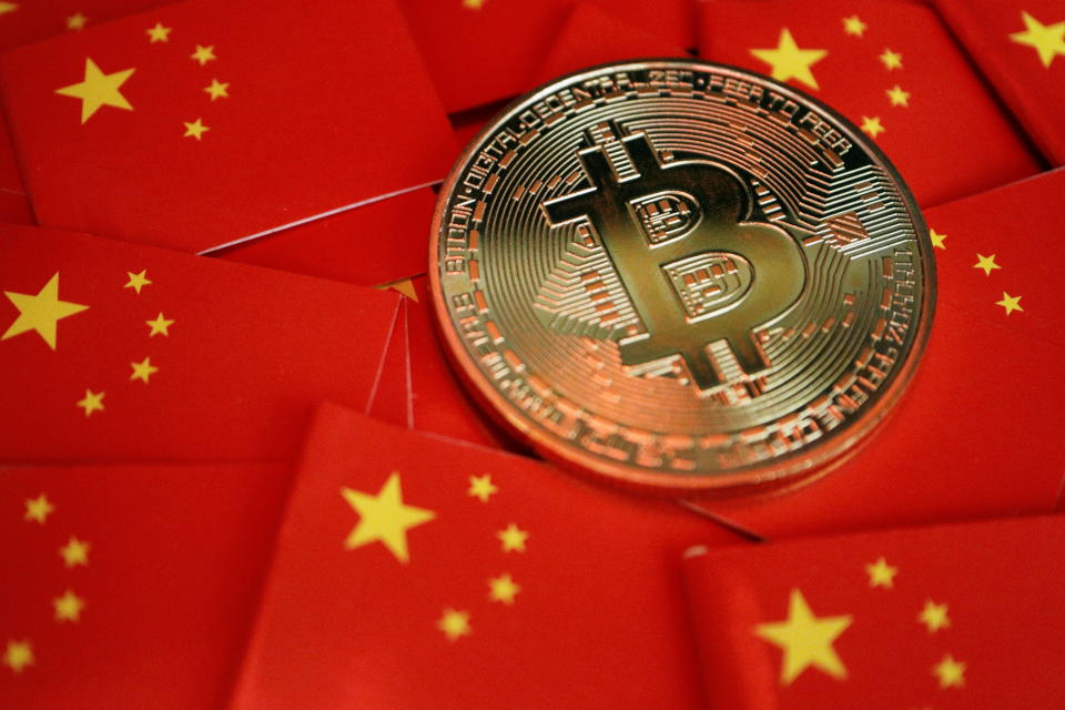 crypto A representation of Bitcoin cryptocurrency is seen among China's flag in this illustration photo taken September 27, 2021. REUTERS/Florence Lo/Illustration