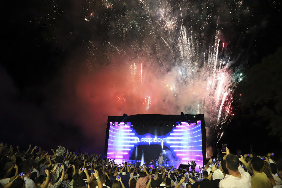 El Salvador's President Nayib Bukele participates in the closing ceremony of a congress for cryptocurrency investors in Santa Maria Mizata, El Salvador, Saturday, Nov. 20, 2021. Bukele announced during the rock concert-like atmosphere at the gathering that his government will build an oceanside "Bitcoin City" at the base of a volcano. (AP Photo/Salvador Melendez)