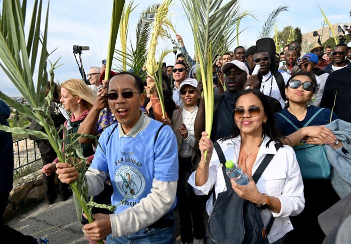 Christians walk in Palm Sunday procession in Jerusalem