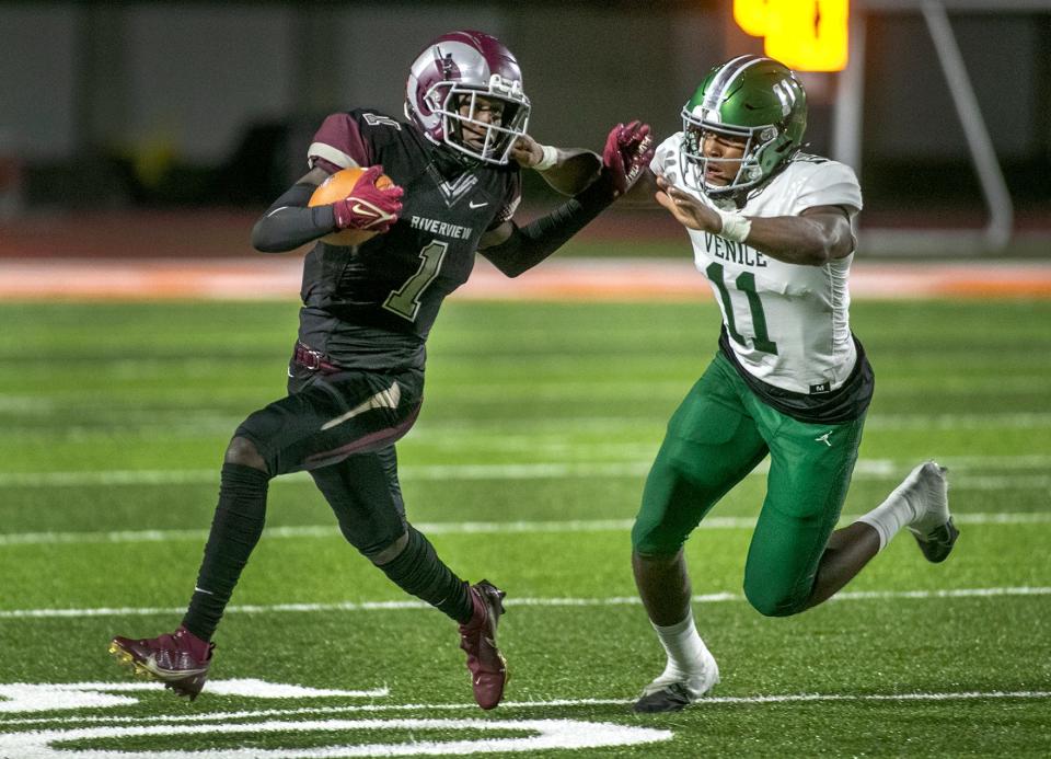 Riverview wide receiver Charles Lester III (1) tries to escape the grip of Venice defensive linebacker Damon Wilson (11) during their schoolÕs matchup up on neutral ground at Sarasota HIgh School. MATT HOUSTON/HERALD-TRIBUNE