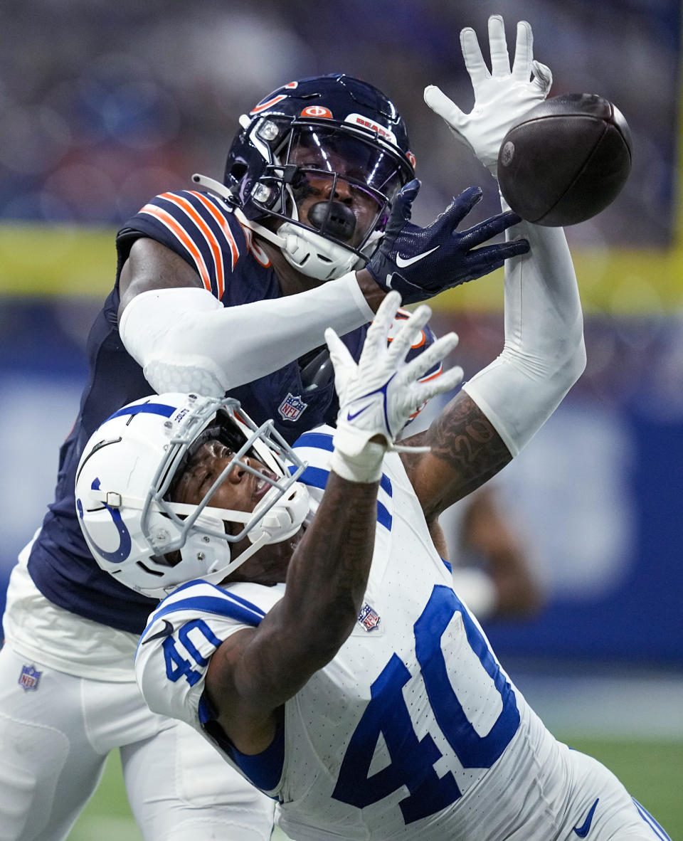 Indianapolis Colts cornerback Jaylon Jones (40) and Chicago Bears wide receiver Daurice Fountain (82) reach for a Bears pass attempt during the second half of an NFL preseason football game in Indianapolis, Saturday, Aug. 19, 2023. (AP Photo/Darron Cummings)