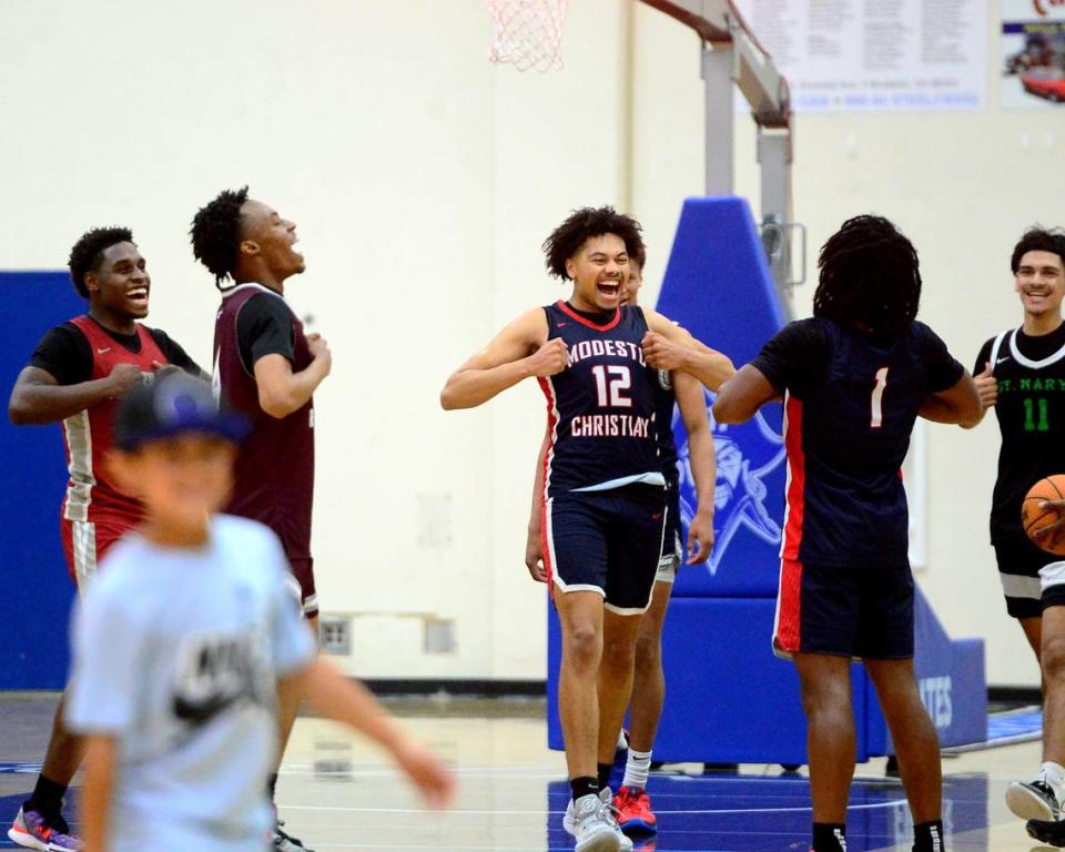 Modesto Christians Marcus Washington (12) celebrates with teammate Jeremiah Bernard (1) after winning the 27th Annual Six County All Star Senior Basketball Classic Boys game at Modesto Junior College in Modesto California on April 27, 2024.