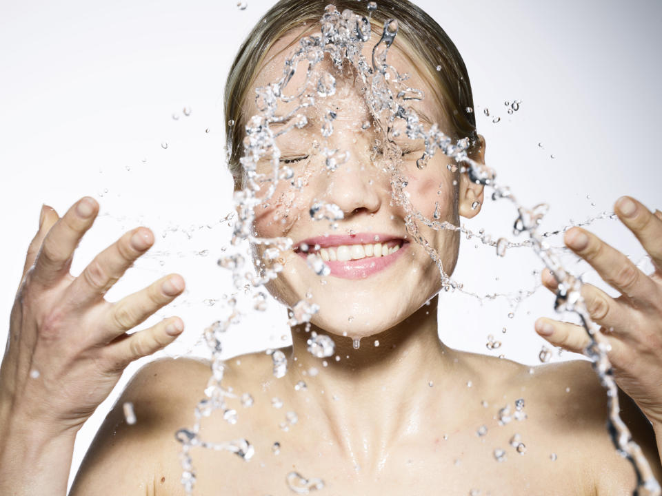 woman splashing water on her face