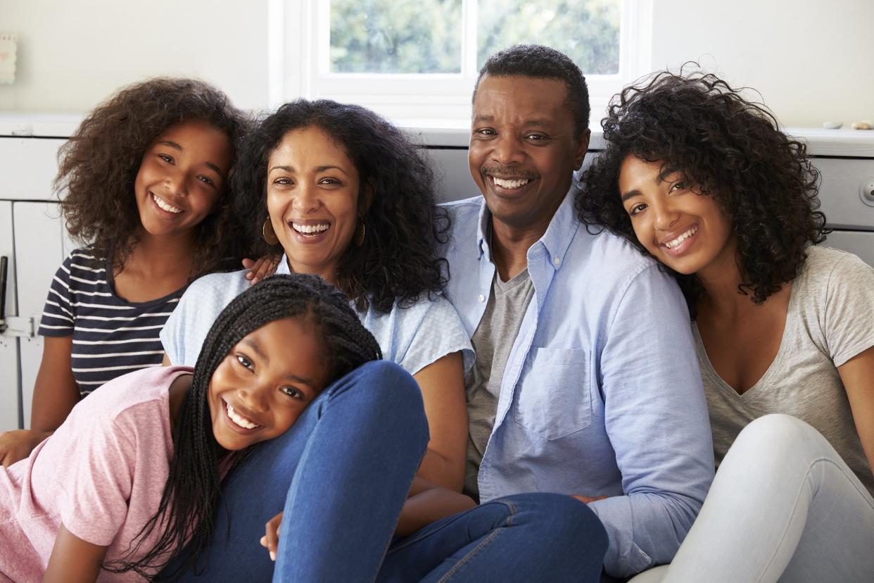 smiling African American family relaxing on seat at home