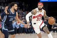 Toronto Raptors guard Gary Trent Jr. (33) handles the ball against Memphis Grizzlies guard Tyus Jones (21) in the first half of an NBA basketball game Sunday, Feb. 5, 2023, in Memphis, Tenn. (AP Photo/Brandon Dill)