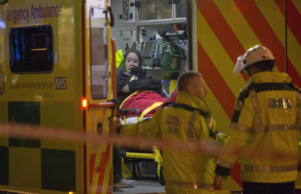 A woman receives medical attention after part of the ceiling at the Apollo Theatre on Shaftesbury Avenue collapsed in central London December 19, 2013. Emergency services said 65 people had been injured in the packed London theatre on Thursday when part of the ceiling collapsed during a performance, showering the audience with masonry and debris. The incident occurred at about 8:30 p.m. at the Apollo Theatre, where many families were among the audience for "The Curious Incident of the Dog in the Night-Time". REUTERS/Neil Hall (BRITAIN - Tags: DISASTER ENTERTAINMENT)