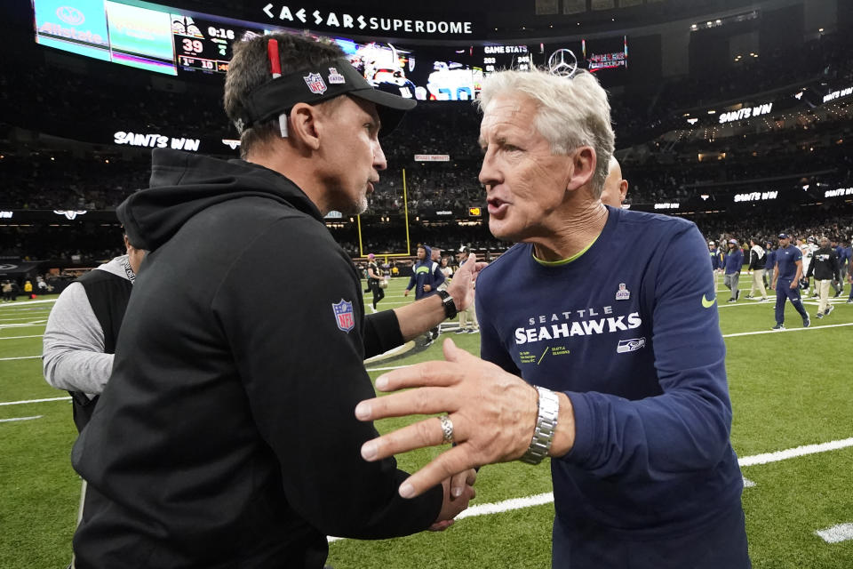 Seattle Seahawks head coach Pete Carroll, right, and New Orleans Saints Dennis Allen shake hands after the Saints 39-32 win over the Seahawks in an NFL football game in New Orleans, Sunday, Oct. 9, 2022. (AP Photo/Derick Hingle)