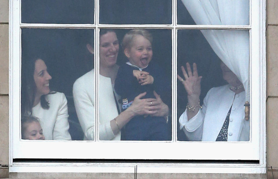 Prince George waves from the window of Buckingham Palace as he watches the Trooping the Colour on June 13, 2015, in London, England.