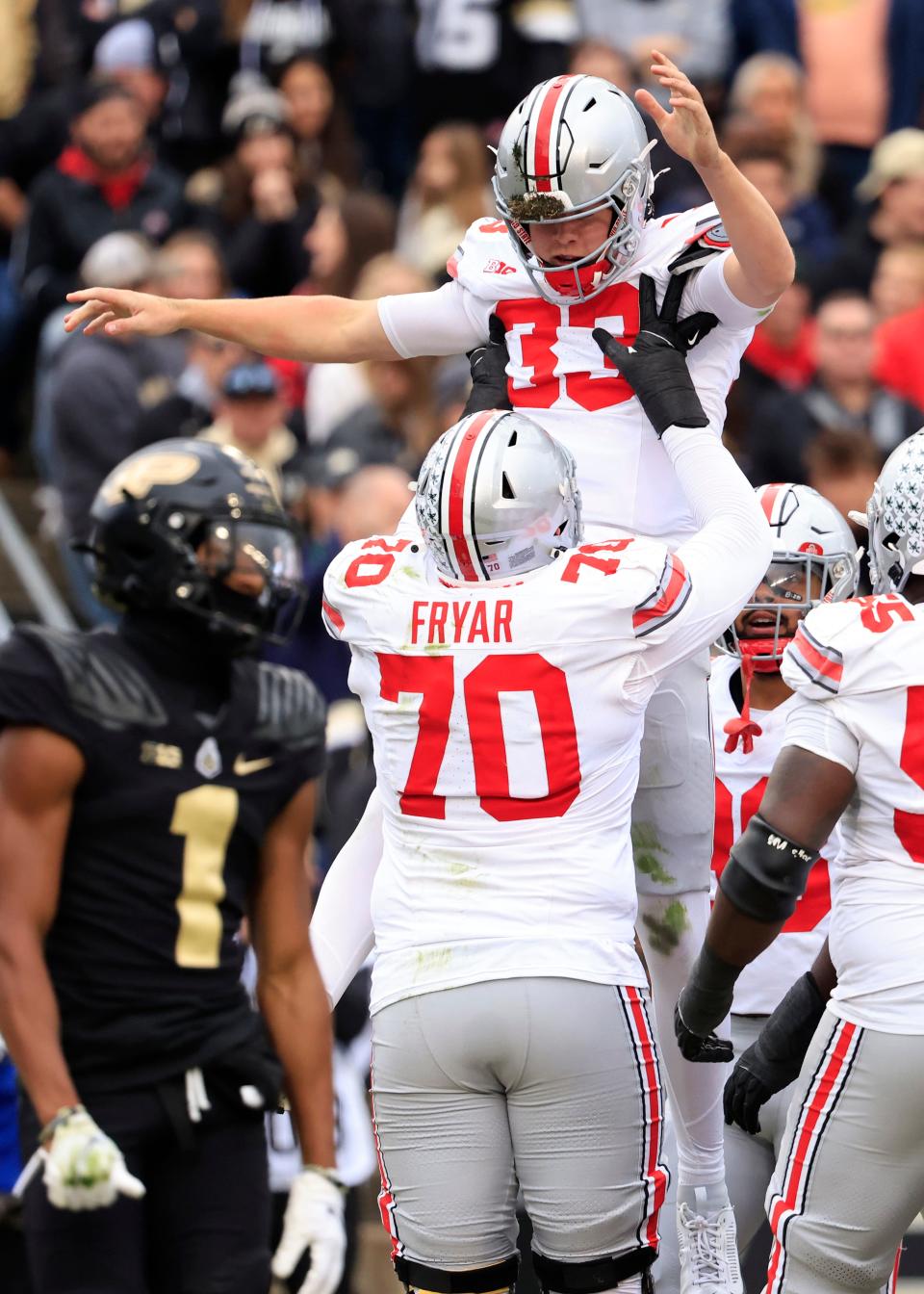 Devin Brown #33 of the Ohio State Buckeyes celebrates a touchdown with Josh Fryar #70 during the first half against the Purdue Boilermakers at Ross-Ade Stadium on October 14, 2023 in West Lafayette, Indiana.