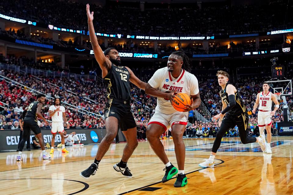 Mar 23, 2024; Pittsburgh, PA, USA; North Carolina State Wolfpack forward DJ Burns Jr. (30) drives to the basket against Oakland Golden Grizzlies forward Tuburu Naivalurua (12) during the first half in the second round of the 2024 NCAA Tournament at PPG Paints Arena. Mandatory Credit: Gregory Fisher-USA TODAY Sports