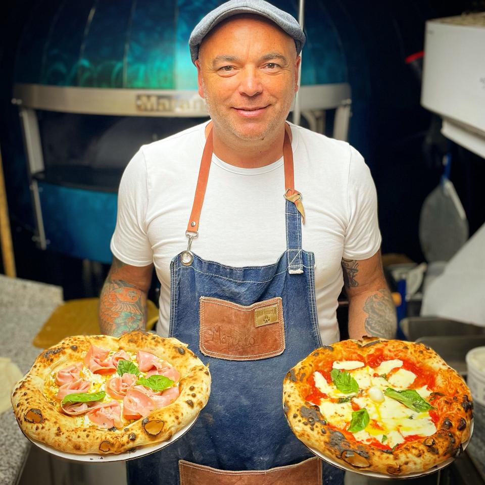 Marcelo Rossano holds two pizzas inside his converted 26-foot Airstream. Though he only started out in the pizza business a few years ago, Rossano has developed an impressive following. That following has jumped up even more now that he sells pizzas outside DRV PNK Stadium in Fort Lauderdale during Inter Miami CF's home games. With Messi madness in full swing and the games selling out, Rossano said they sold over 400 pizzas during the home opener on July 21.