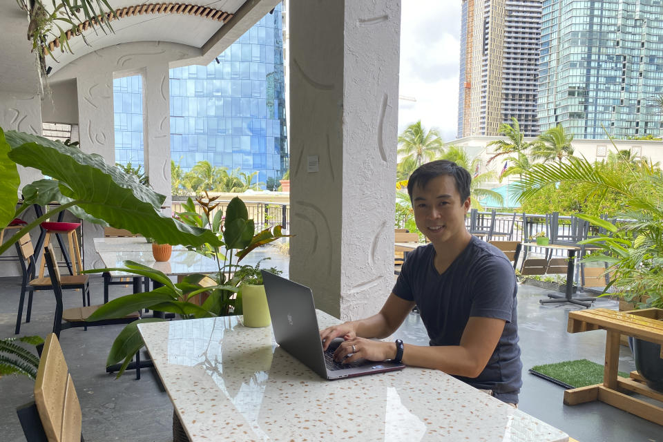 In this photo provided by Ashley McCue, Richard Matsui works from a coworking space on Nov. 18, 2020, in Honolulu. A group of Hawaii leaders is trying to attract more people like Matsui to work remotely in Hawaii during the pandemic. (Ashley McCue via AP)