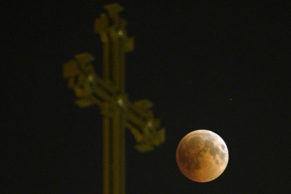 The moon passes over an Armenian Apostolic Church cathedral in Yerevan. (Photo: KAREN MINASYAN via Getty Images)