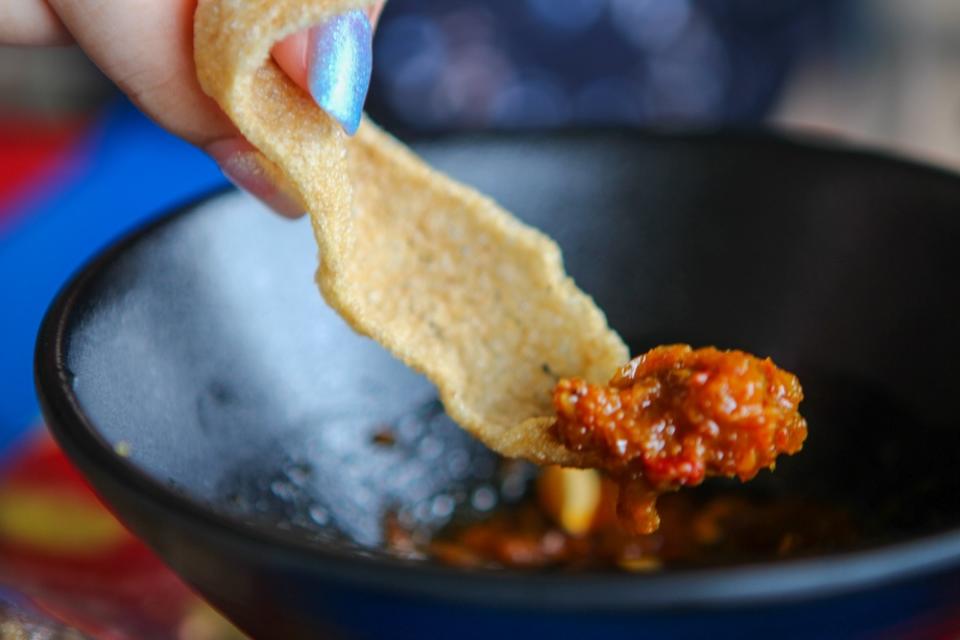 Fish cracker dipped in sambal