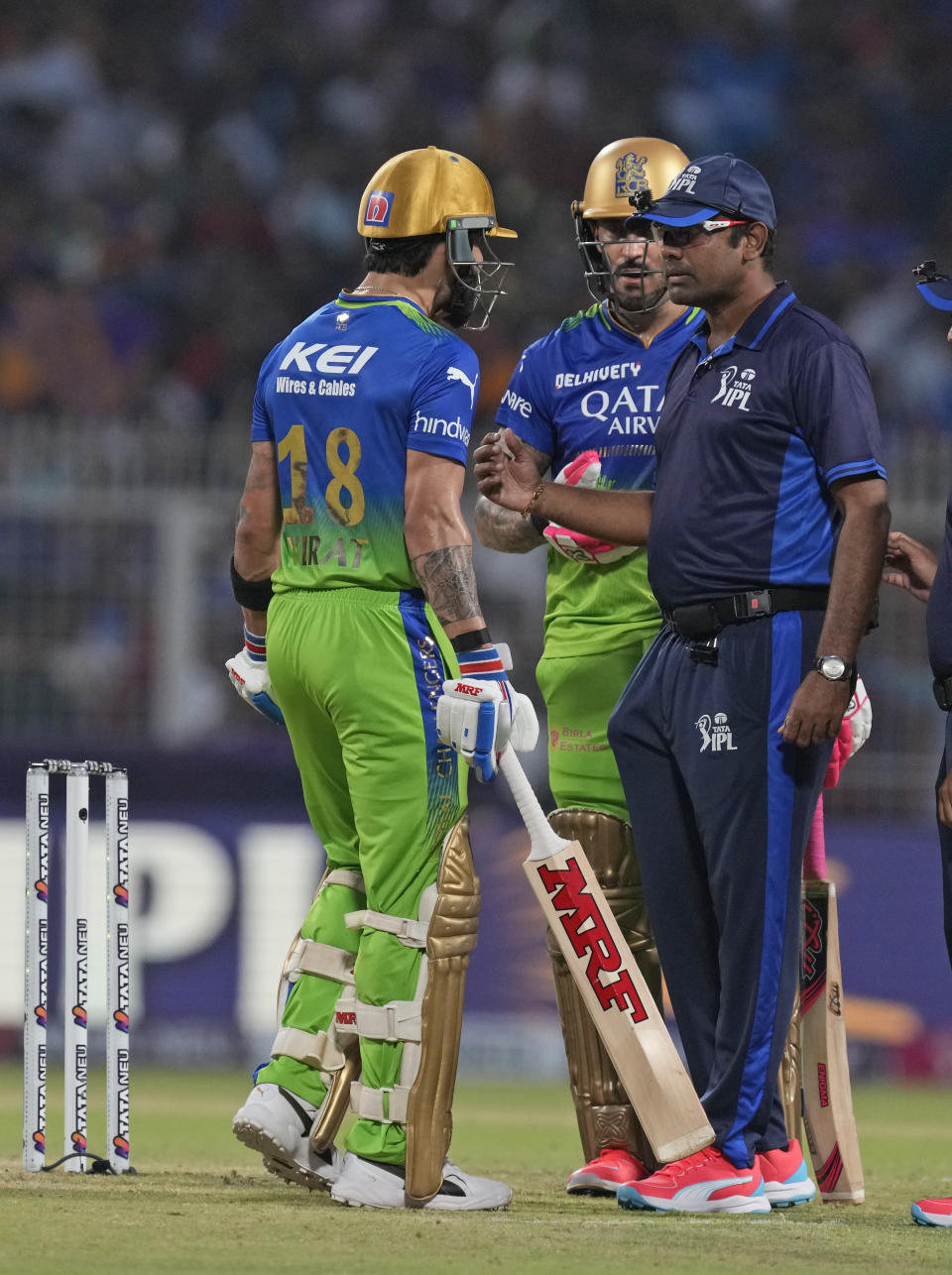 Royal Challengers Bengaluru's Virat Kohli chats with the umpire after he is given out during the Indian Premier League cricket match between Kolkata Knight Riders and Royal Challengers Bengaluru in Kolkata, India, Sunday, April 21, 2024. (AP Photo/Bikas Das)