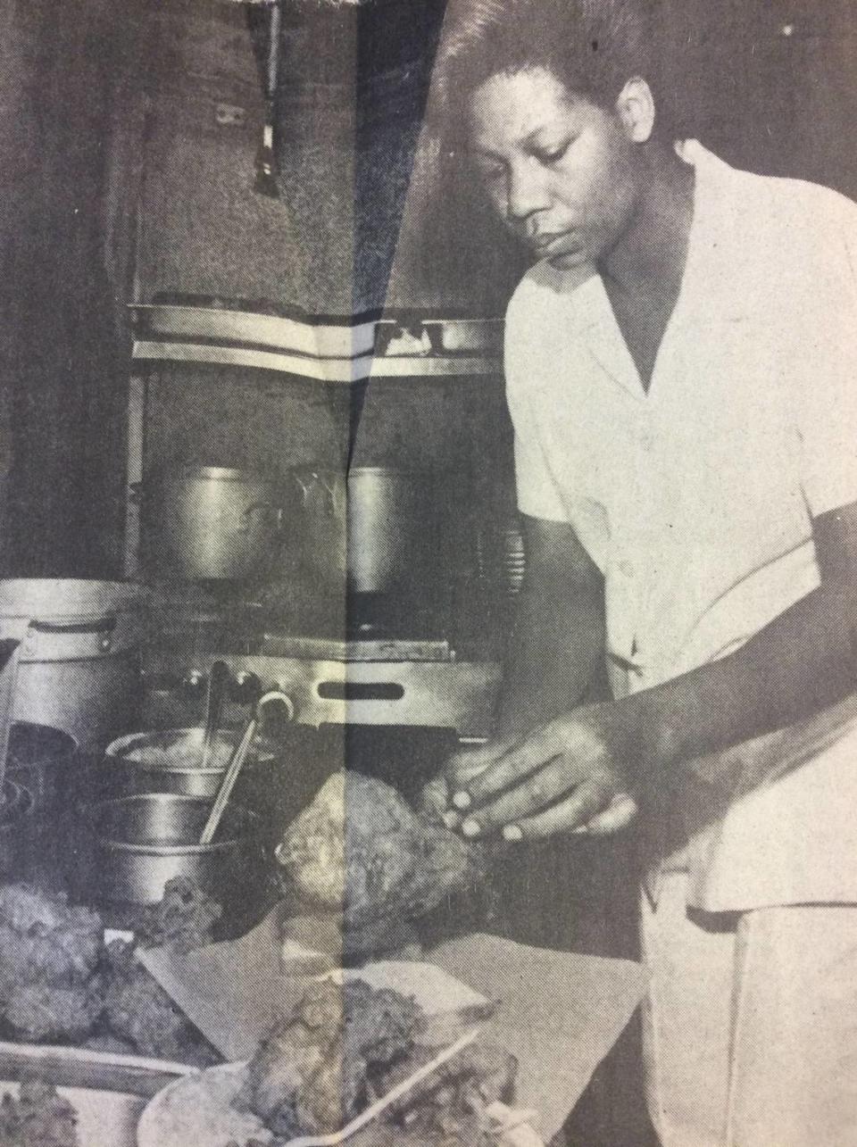 Eula Reese serves up chicken from Top Hat Cafe in 1983.