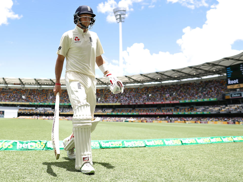 Joe Root trudges off the Gabba pitch after being dismissed LBW by Josh Hazlewood: Getty