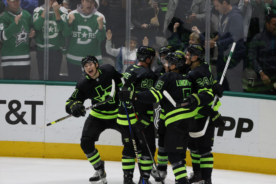 Dallas Stars left wing Jason Robertson, left, celebrates his goal against the New York Rangers during the second period of an NHL hockey game in Dallas, Saturday, Oct. 29, 2022. (AP Photo/Michael Ainsworth)