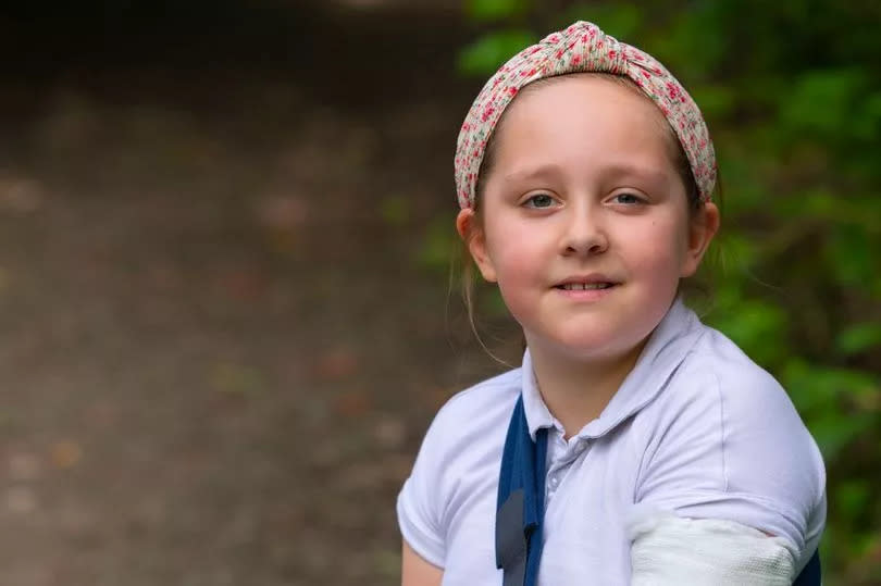 Abigail wearing a cast on her arm