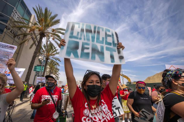 A woman calls for rent relief during a march for workers and human rights in Los Angeles on May 1. California's governor has proposed paying off qualifying residents' unpaid rent during the pandemic. (Photo: DAVID MCNEW via Getty Images)