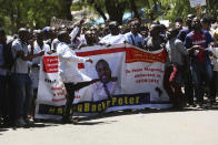 Zimbabwean doctors sing and dance as they protest in Harare, Wednesday, Sept, 18, 2019. Zimbabwean doctors protesting the alleged abduction of a union leader were met by a line of baton- wielding police in the capital as fears grow about government repression. (AP Photo/Tsvangirayi Mukwazhi)