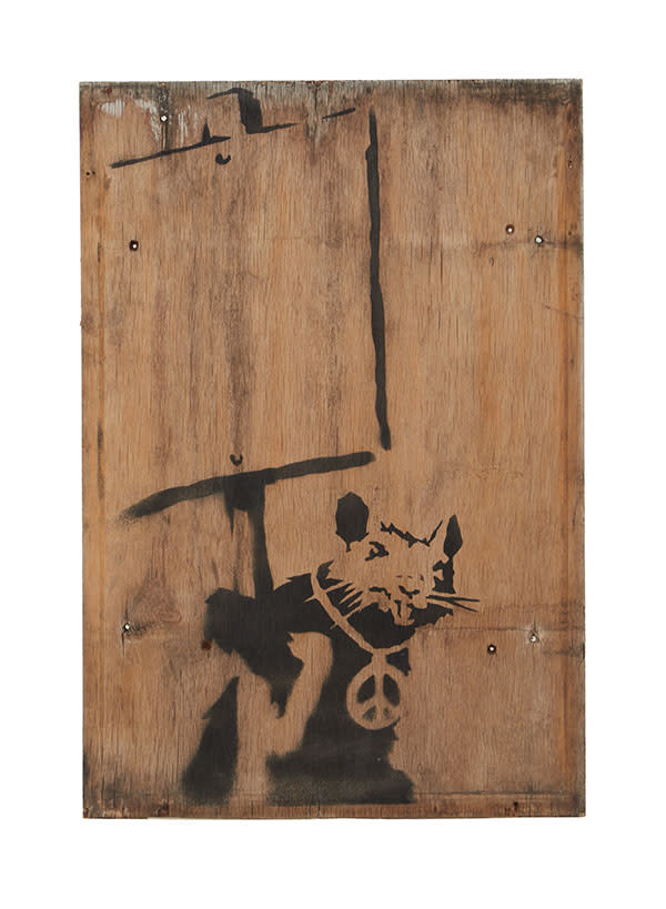 One of Banksy's Placard Rats holding up a blank sign