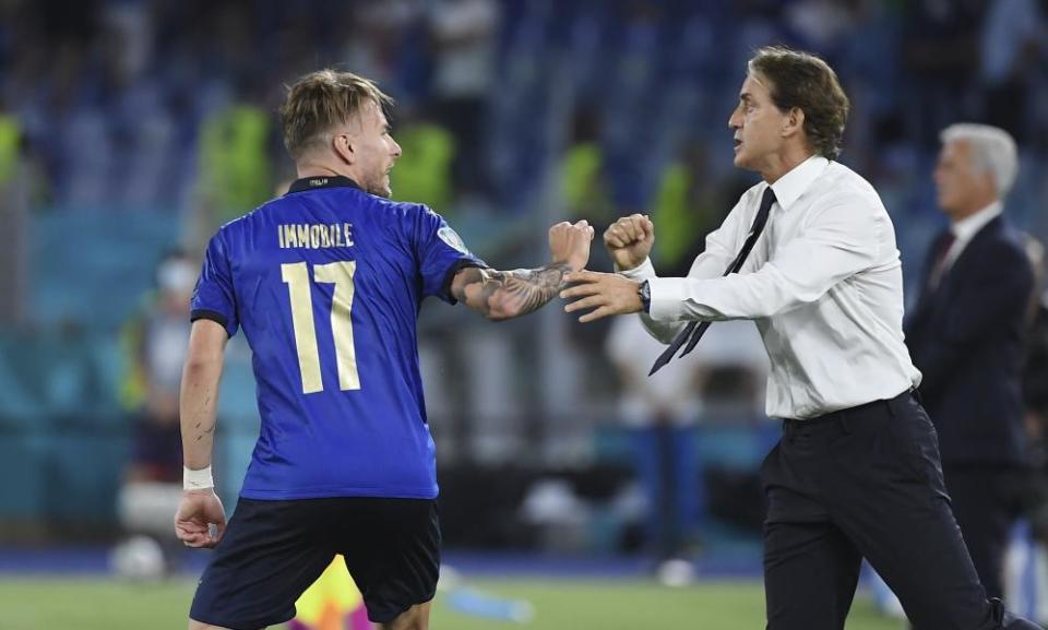 Ciro Immobile celebrates with his coach Roberto Mancini after scoring Italy’s third goal against Switzerland