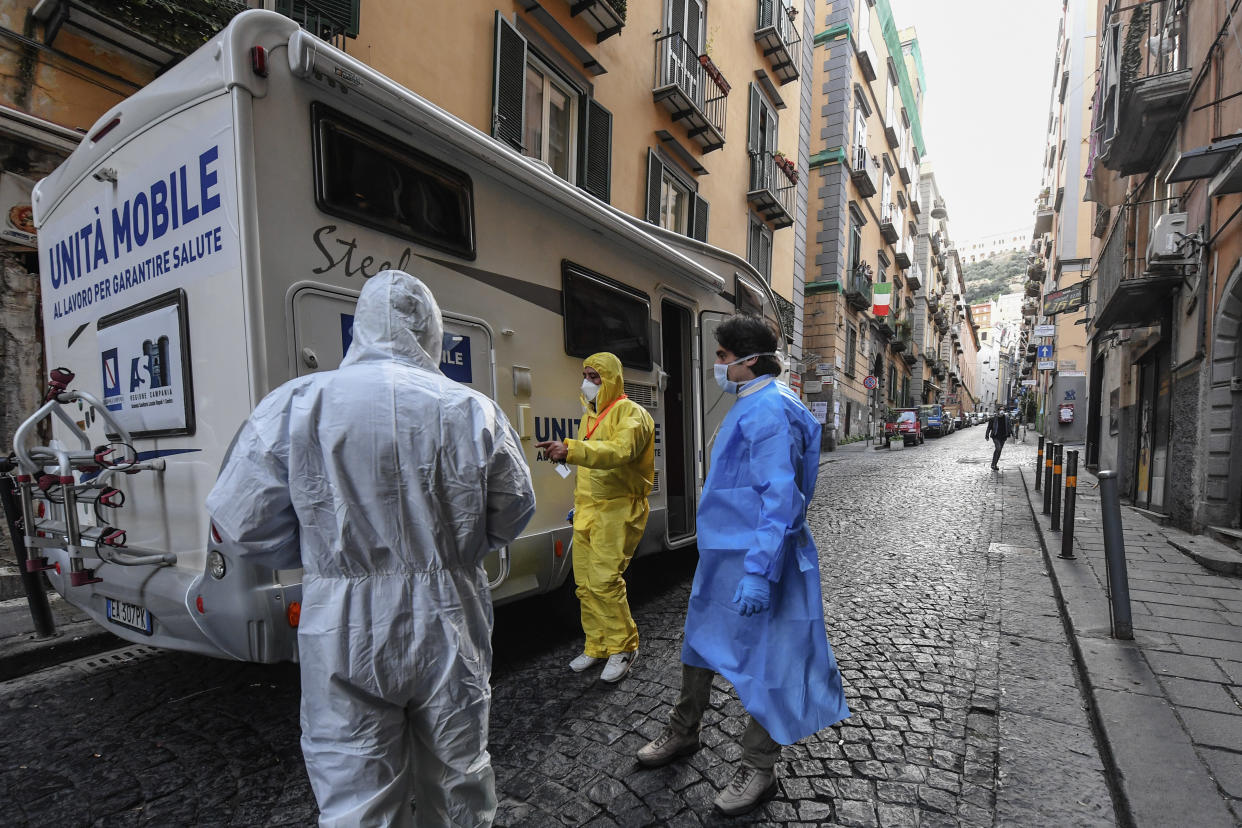 NAPLES, CAMPANIA, ITALY - 2020/03/29: Doctors, protected by overalls, masks, gloves and glasses, collect the swabs made to some inhabitants of the Spanish Quarters to check for any contagion from Coronavirus (COVID-19). For the collection of the swabs they also use a mobile sanitary unit. (Photo by Salvatore Laporta/KONTROLAB/LightRocket via Getty Images)