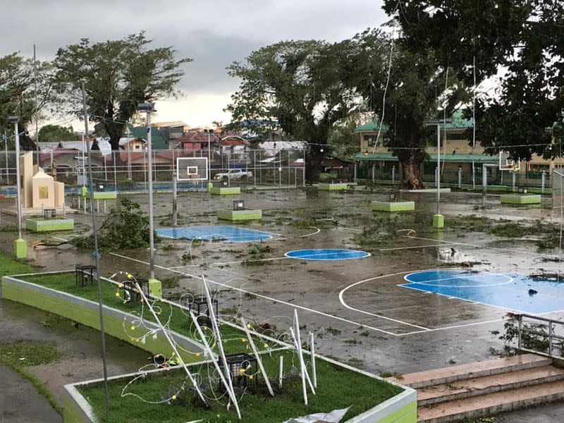 Fallen tree branches litter a basketball court after Typhoon Phanfone swept through Tanauan, Leyte, in the Philippines