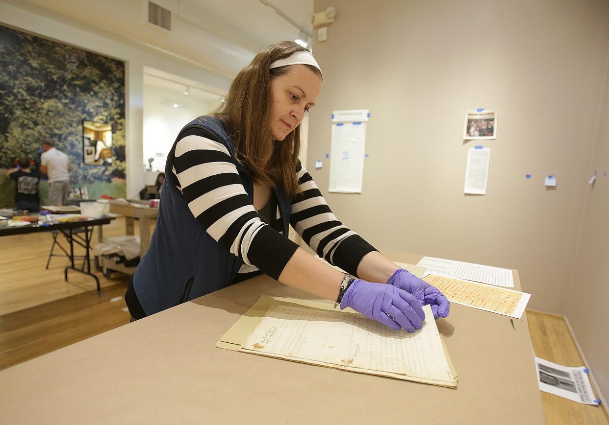 Mandy Alltimus Stahl, an archivist at the Massillon Museum, puts together a display of Freedom Papers for slaves from Virginia who moved to Massillon. The museum launches a new exhibit Saturday focused on the history of the community's Black residents and culture.