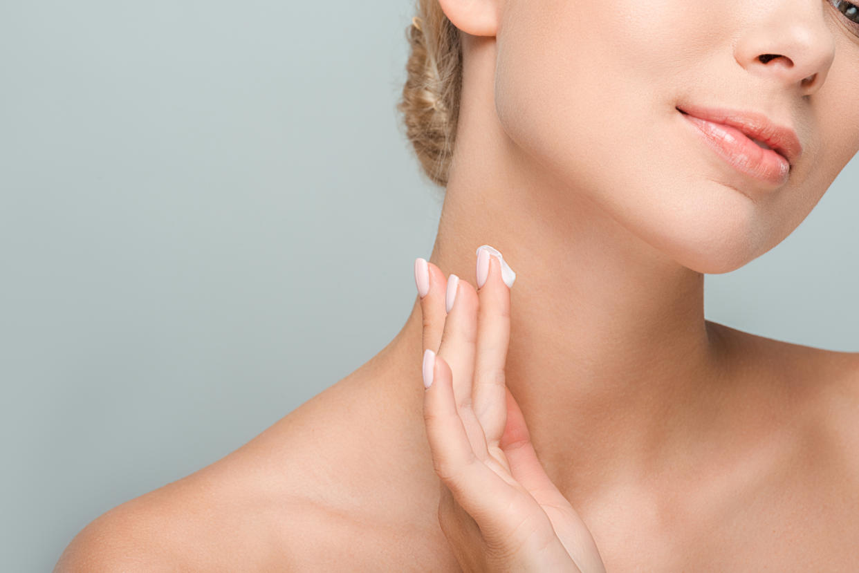 Woman-Applying-Neck-Cream-Stock-Photo