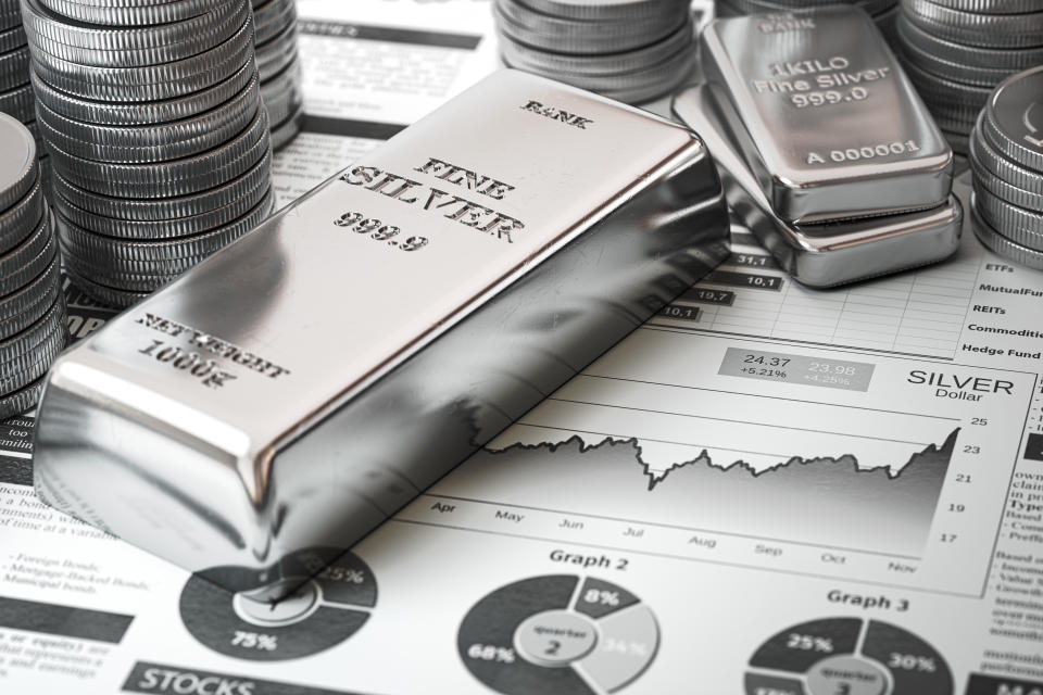 Silver bar, ingots and coins on financial  report. Growth of silver on stock market concept. 3d illustration