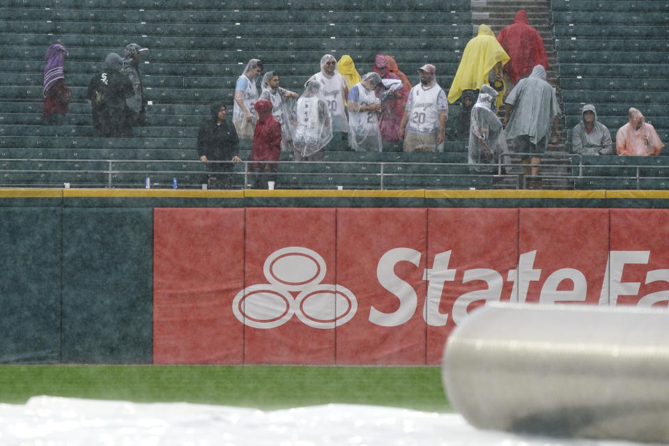 Fans look to the field as they wait during a rain delay in the third inning of a baseball game between the Seattle Mariners and the Chicago White Sox in Chicago, Saturday, June 26, 2021. (AP Photo/Nam Y. Huh)