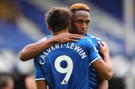 Everton's English striker Dominic Calvert-Lewin (L) and Everton's Colombian defender Yerry Mina react at the final whistle during the English Premier League football match between Everton and Liverpool at Goodison Park in Liverpool, north west England on October 17, 2020. (Photo by Peter Byrne / POOL / AFP) / RESTRICTED TO EDITORIAL USE. No use with unauthorized audio, video, data, fixture lists, club/league logos or 'live' services. Online in-match use limited to 120 images. An additional 40 images may be used in extra time. No video emulation. Social media in-match use limited to 120 images. An additional 40 images may be used in extra time. No use in betting publications, games or single club/league/player publications. / (Photo by PETER BYRNE/POOL/AFP via Getty Images)