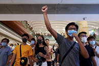 Protesters shout slogans at a shopping mall in Hong Kong, Saturday, Sept. 7, 2019. Hong Kong authorities were limiting airport transport services and controlling access to terminals Saturday as they braced for the second weekend of disruption following overnight demonstrations that turned violent. (AP Photo/Vincent Yu)