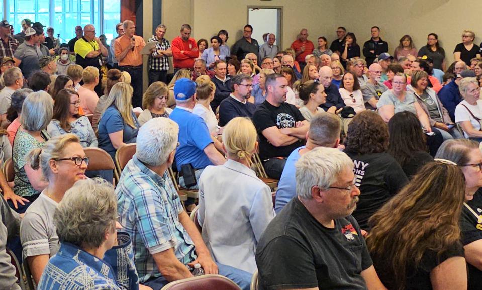 North East residents listen as an audience member asks officials from Granite Ridge and Culmen International a question about the campus being used as an influx care facility for unaccompanied migrant children on Thursday, May 11, 2023.