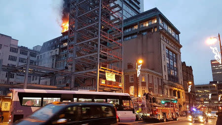 An apartment block on fire is seen in Manchester, Britain December 30, 2017 in this image obtained from social media. TWITTER/@MANCTRAFFIC/via REUTERS.