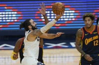 Minnesota Timberwolves guard Ricky Rubio, left, shoots against the Golden State Warriors during the first half of an NBA basketball game in San Francisco, Monday, Jan. 25, 2021. (AP Photo/Jeff Chiu)