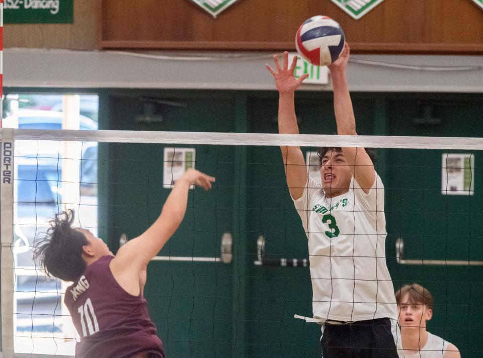 St. Mary's Jayden Hernandez, right, attempts to block a spike by Edison's Nicholas Vang during a Sac-Joaquin Section boys volleyball playoff match at St. Mary's in Stockton on May. 2, 2024.