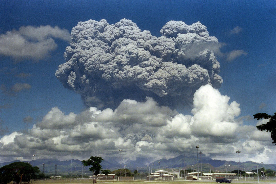FILE PHOTO: A giant volcanic mushroom cloud explodes some 20 kilometers high from Mount Pinatubo above almost deserted US Clark Air Base, on June 12, 1991 followed by another more powerful explosion.  (Photo: ARLAN NAEG/AFP via Getty Images)