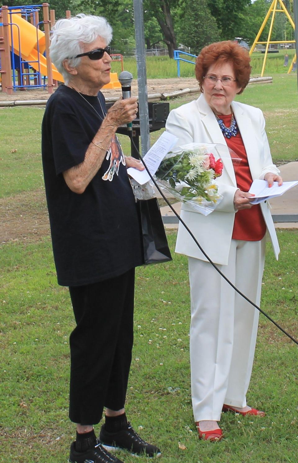 Janette Barlow of Wimberley, Texas, left, talked about Gail Shanahan who died in the Webbers Falls Bridge collapse in 20902. Former Mayor Jewell Hall, organizer of the memorial ceremony Monday, May 30, is on the right holding a program.