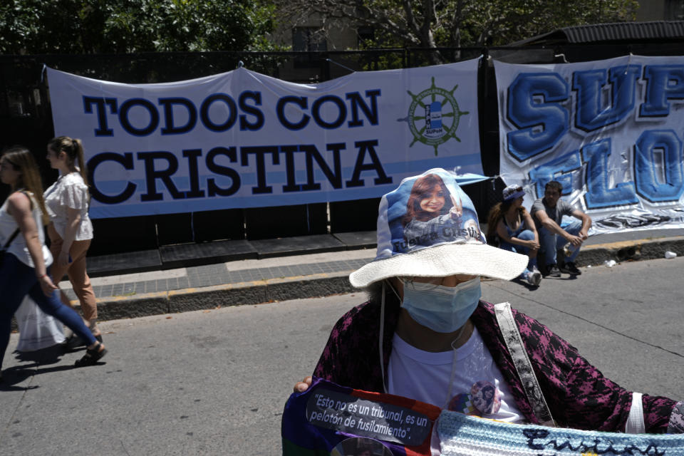 Supporters of Argentine Vice President Cristina Fernandez, a former president, gather outside the court where judges are expected to announce the verdict in a corruption case against her in Buenos Aires, Argentina, Tuesday, Dec. 6, 2022. The banner reads in Spanish "Everyone with Cristina." Three judges will soon announce their verdict in the corruption trial of Fernandez, accused of running a criminal organization that fraudulently directed about $1 billion in public works projects to her longtime ally when she was president. (AP Photo/Rodrigo Abd)