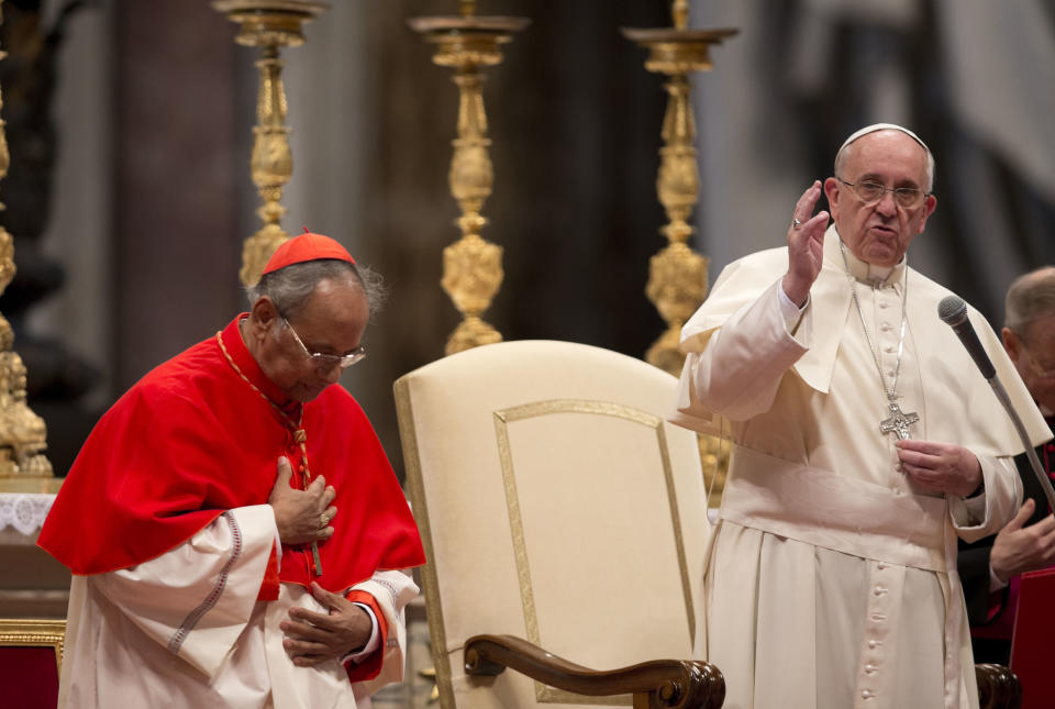 Pope Francis, right, delivers his blessing flanked by Cardinal Albert Malcolm Ranjith, of Sri Lanka, after a mass for the Sri lankan community in St. Peter's Basilica at the Vatican, Saturday, Feb. 8, 2014. (AP Photo/Alessandra Tarantino)