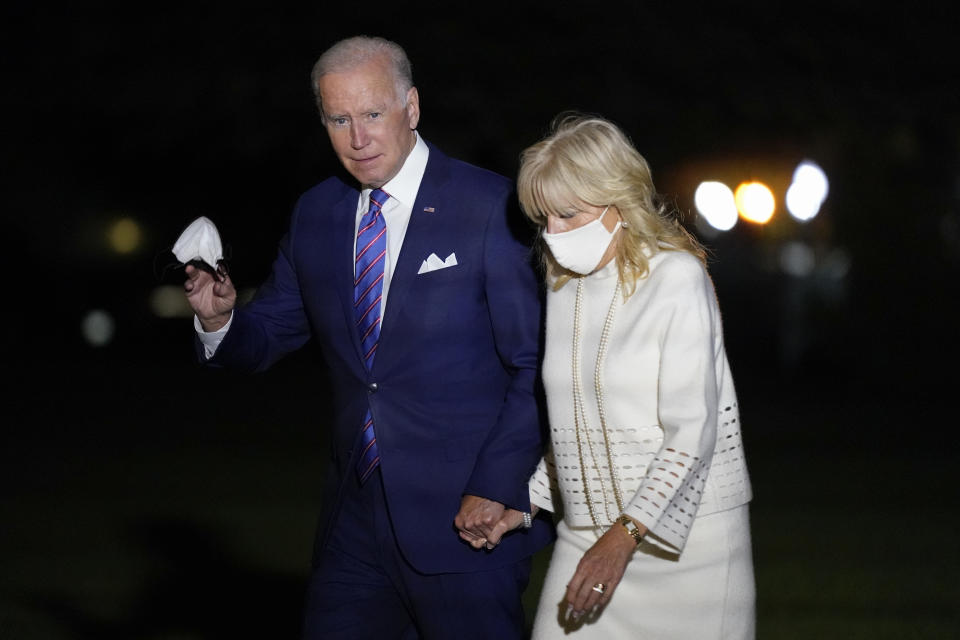 President Joe Biden waves as he and first lady Jill Biden walk on the South Lawn of the White House after stepping off Marine One, Thursday, Oct. 21, 2021, in Washington. The Bidens are returning from a CNN town hall in Baltimore. (AP Photo/Patrick Semansky)