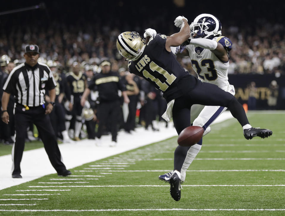 FILE - New Orleans Saints wide receiver Tommylee Lewis (11) works for a catch against Los Angeles Rams defensive back Nickell Robey-Coleman (23) during the second half of the NFL football NFC championship game, in New Orleans, Jan. 20, 2019. Rams cornerback Nickell Robey-Coleman could have been cited for pass interference and helmet-to-helmet contact for flattening Saints receiver Tommylee Lewis inside the 10-yard line with 1:45 left in the fourth quarter of a game that was tied. Two officials were right nearby; neither tossed a flag. The Rams won 26-23. (AP Photo/Gerald Herbert, File)