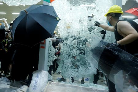 FILE PHOTO: Protesters break the windows of the Legislative Council building on the anniversary of Hong Kong's handover to China in Hong Kong