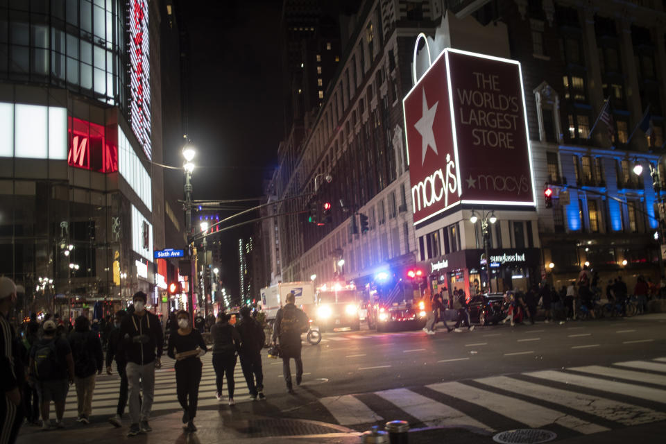 New York police officers park their vehicles outside Macy's store after it was broken into hours after a solidarity rally calling for justice over the death of George Floyd, Monday, June 1, 2020, in New York. Floyd died after being restrained by Minneapolis police officers on May 25. (AP Photo/Wong Maye-E)